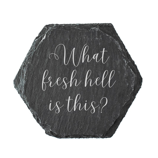 Hexagonal black slate coaster with white text 'What fresh hell is this?' on a white background