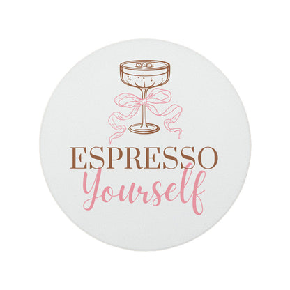 Round ceramic coaster featuring the witty quote "Espresso yourself" in warm brown and pink text, topped with an illustrated espresso martini glass. 