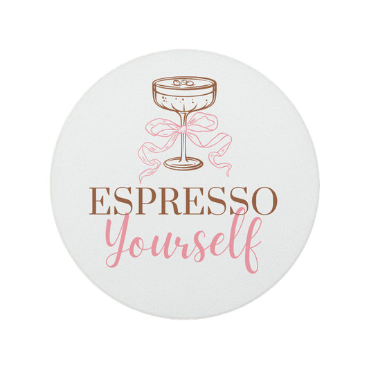 Round ceramic coaster featuring the witty quote "Espresso yourself" in warm brown and pink text, topped with an illustrated espresso martini glass. 