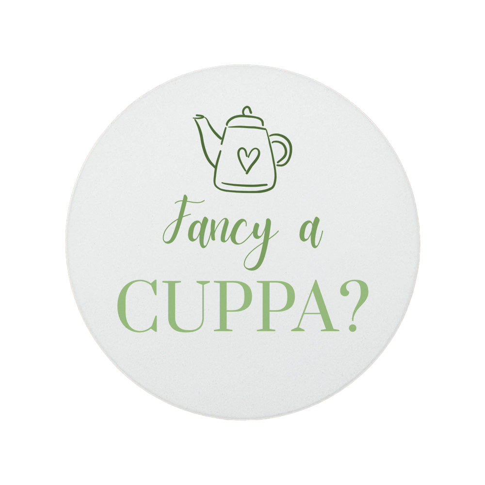 Round ceramic coaster featuring the cheerful quote "Fancy a cuppa?" in crisp green lettering. 