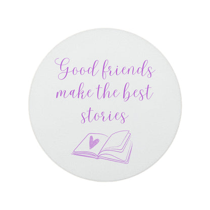 Round ceramic coaster featuring the friendship quote "Good friends make the best stories" in crisp purple lettering with a book illustration underneath.