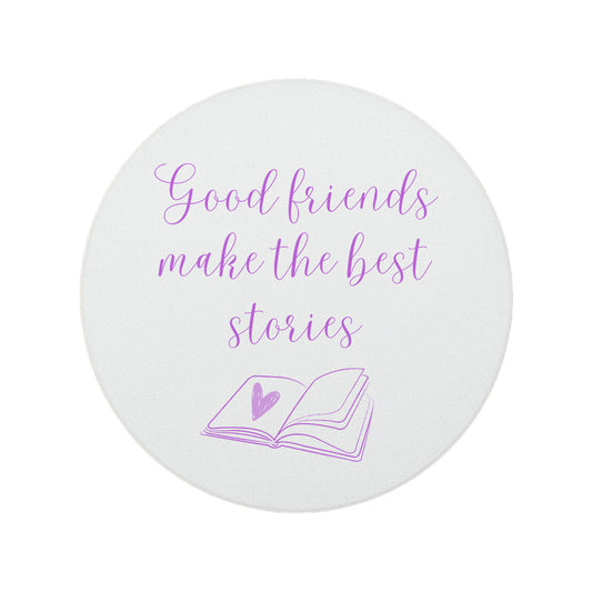 Round ceramic coaster featuring the friendship quote "Good friends make the best stories" in crisp purple lettering with a book illustration underneath.