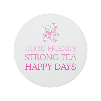 Round ceramic coaster featuring the fun quote "Good friends, strong tea, happy days" in crisp pink lettering with a teacup illustration.