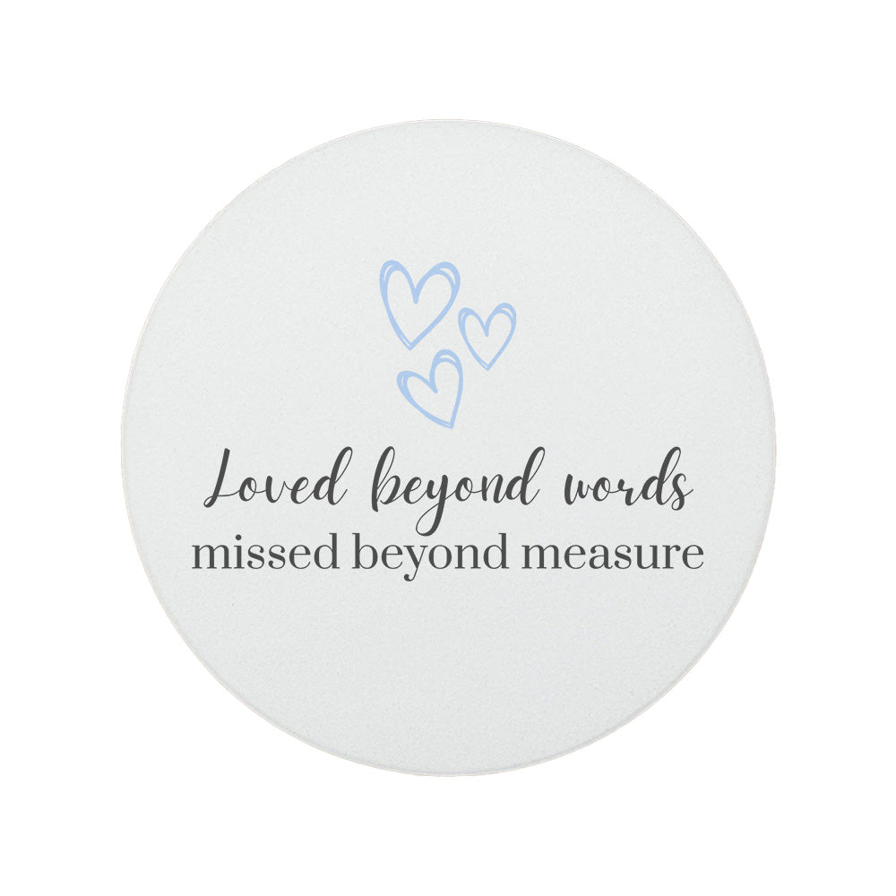 Round ceramic memorial coaster featuring the thoughtful words "Loved beyond words, missed beyond measure". 