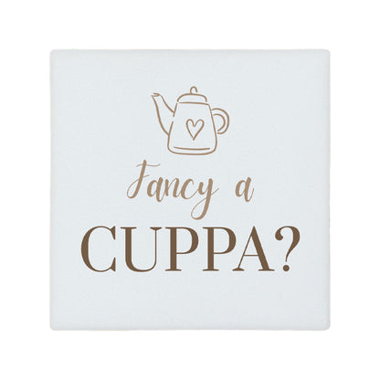 Square ceramic coaster with 'Fancy a cuppa?' quote in brown text.
