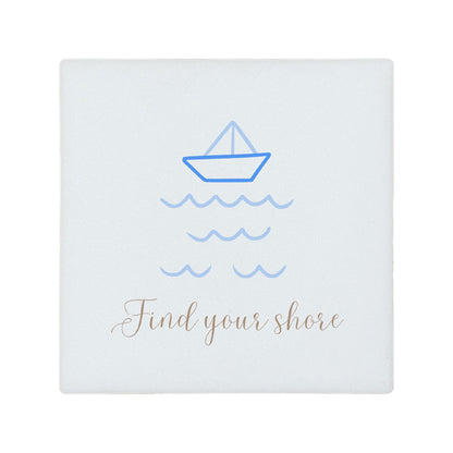 Square ceramic coaster with boat illustration and 'Find your shore' quote in blue and gold. 