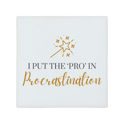 Square ceramic coaster featuring the funny quote "I put the 'pro' in procrastination" in crisp black and gold lettering with a magic wand and stars illustration.