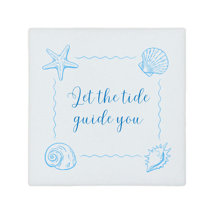 Square ceramic coaster featuring the inspirational quote "Let the tide guide you" in elegant blue lettering with sea shell illustrations.
