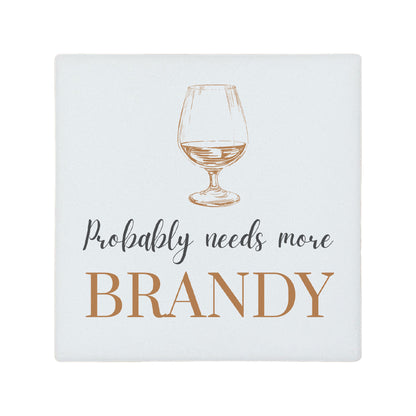 Square ceramic coaster featuring the funny quote "Probably needs more brandy" in crisp grey and brown lettering with a brandy glass illustration.