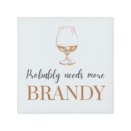Square ceramic coaster featuring the funny quote "Probably needs more brandy" in crisp grey and brown lettering with a brandy glass illustration.