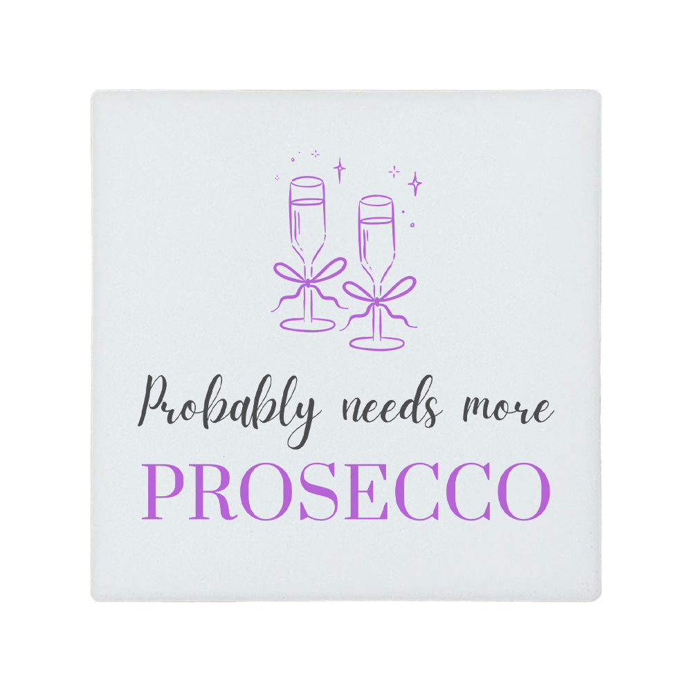 Square ceramic coaster featuring the funny quote "Probably needs more prosecco" in crisp grey and purple lettering with a prosecco glass illustration.