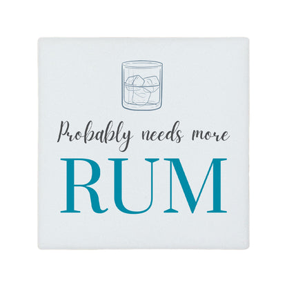Square ceramic coaster featuring the funny quote "Probably needs more rum" in crisp grey and blue lettering with a rum glass illustration.
