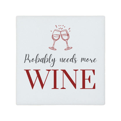 Square ceramic coaster featuring the funny quote "Probably needs more wine" in crisp grey and burgundy lettering with a wine glass illustration. 