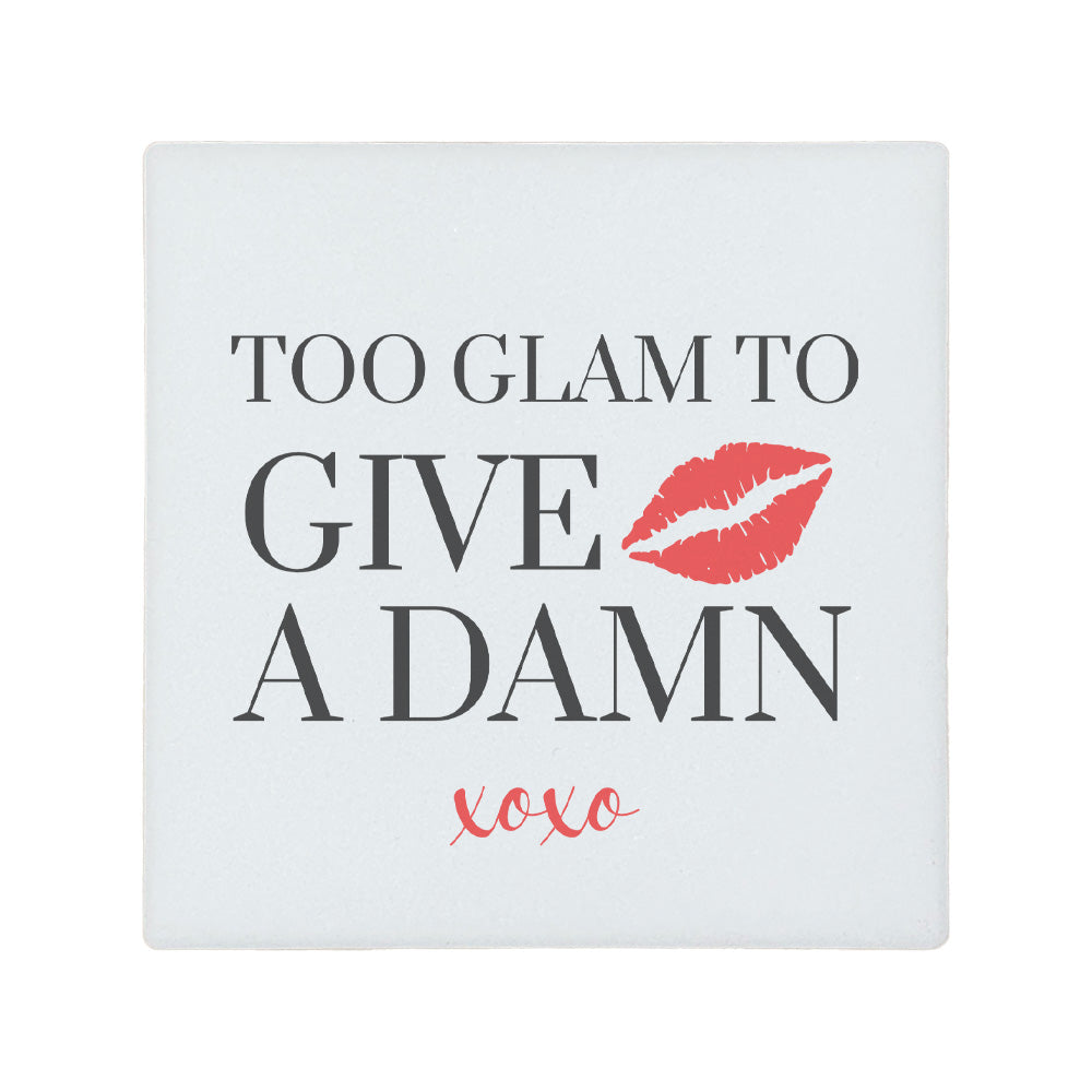Square ceramic coaster featuring the witty quote "Too glam to give a damn" in grey text with a red illustrated lipstick print.