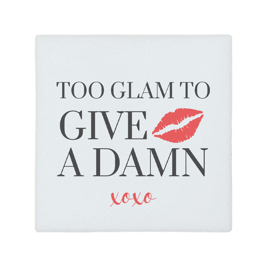 Square ceramic coaster featuring the witty quote "Too glam to give a damn" in grey text with a red illustrated lipstick print.