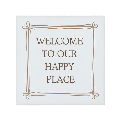 Square ceramic coaster featuring the quote "Welcome to our happy place" in neutral toned lettering with a cute bow border. 
