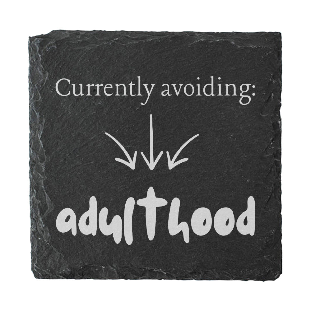 Slate coaster with humorous text 'Currently avoiding: adulthood' on a white background