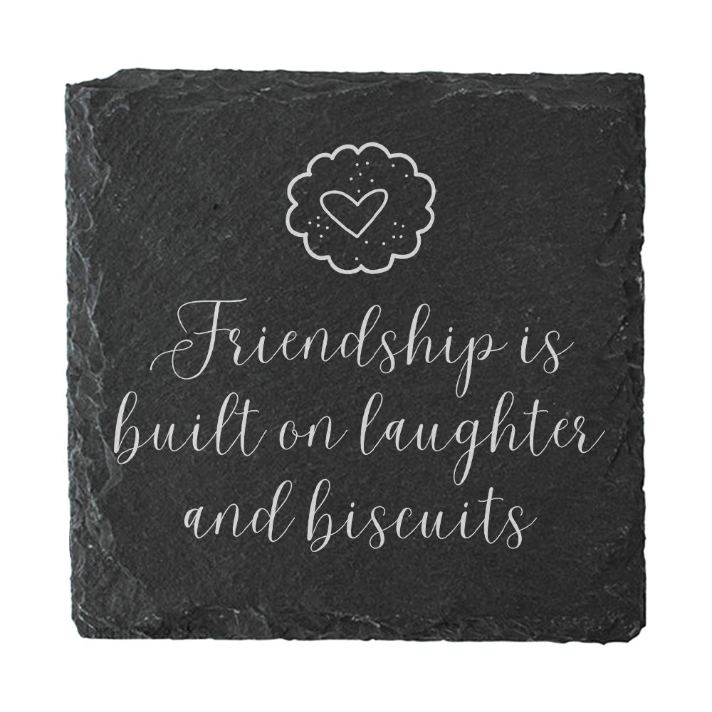 Slate coaster with 'Friendship is built on laughter and biscuits' text and heart design.