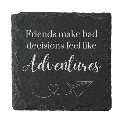 Slate coaster with humorous quote 'Friends make bad decisions feel like Adventures' on a white background