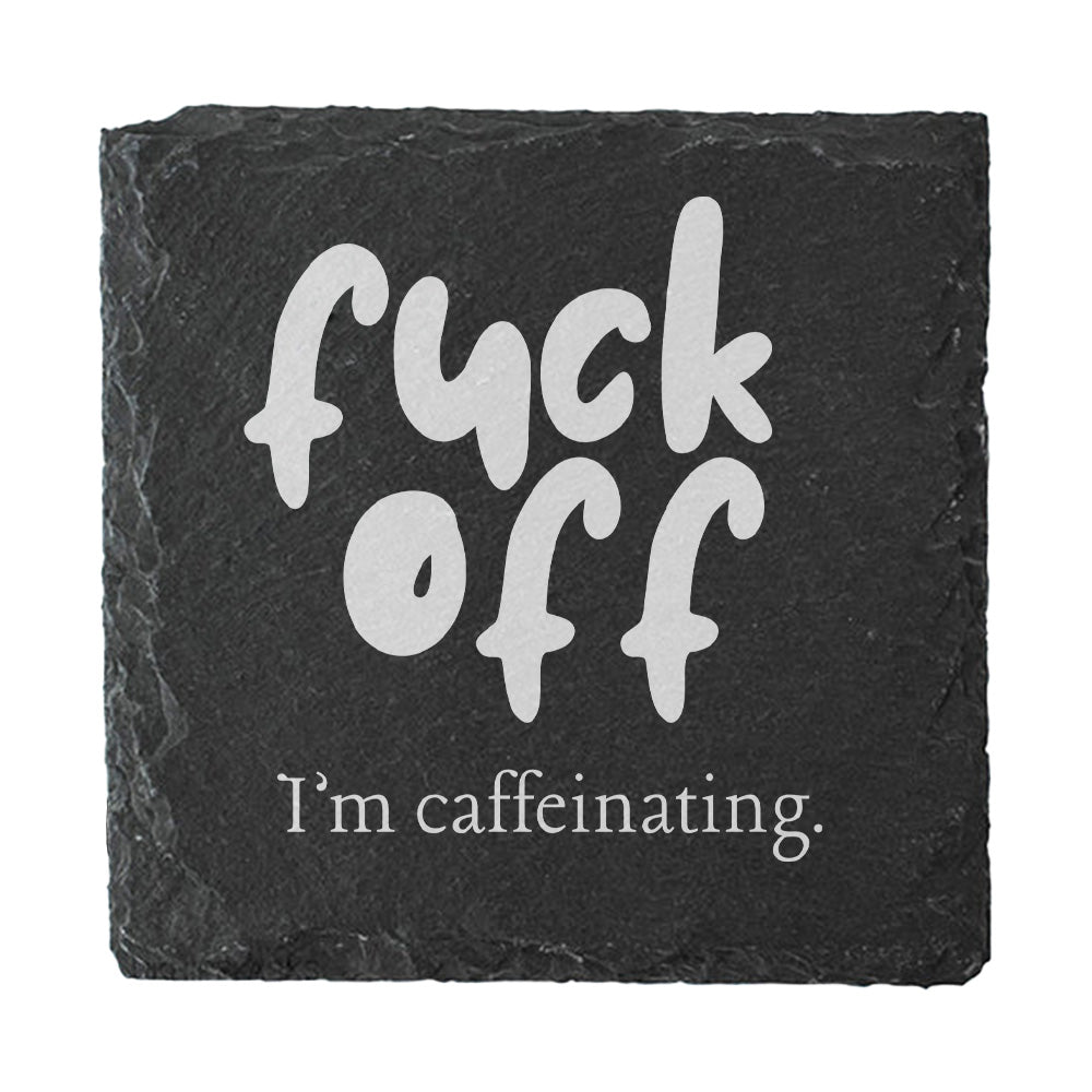 Slate coaster with white text 'fuck off I'm caffeinating' on a black background