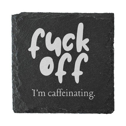 Slate coaster with white text 'fuck off I'm caffeinating' on a black background