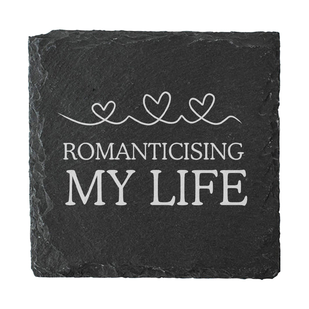Slate coaster with 'Romanticising My Life' text and heart designs on a white background