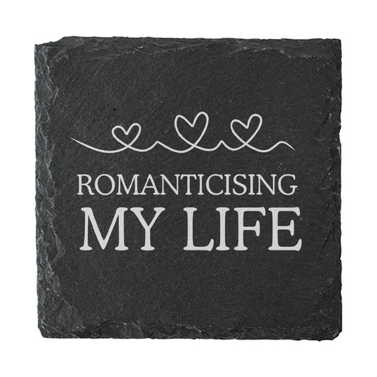 Slate coaster with 'Romanticising My Life' text and heart designs on a white background