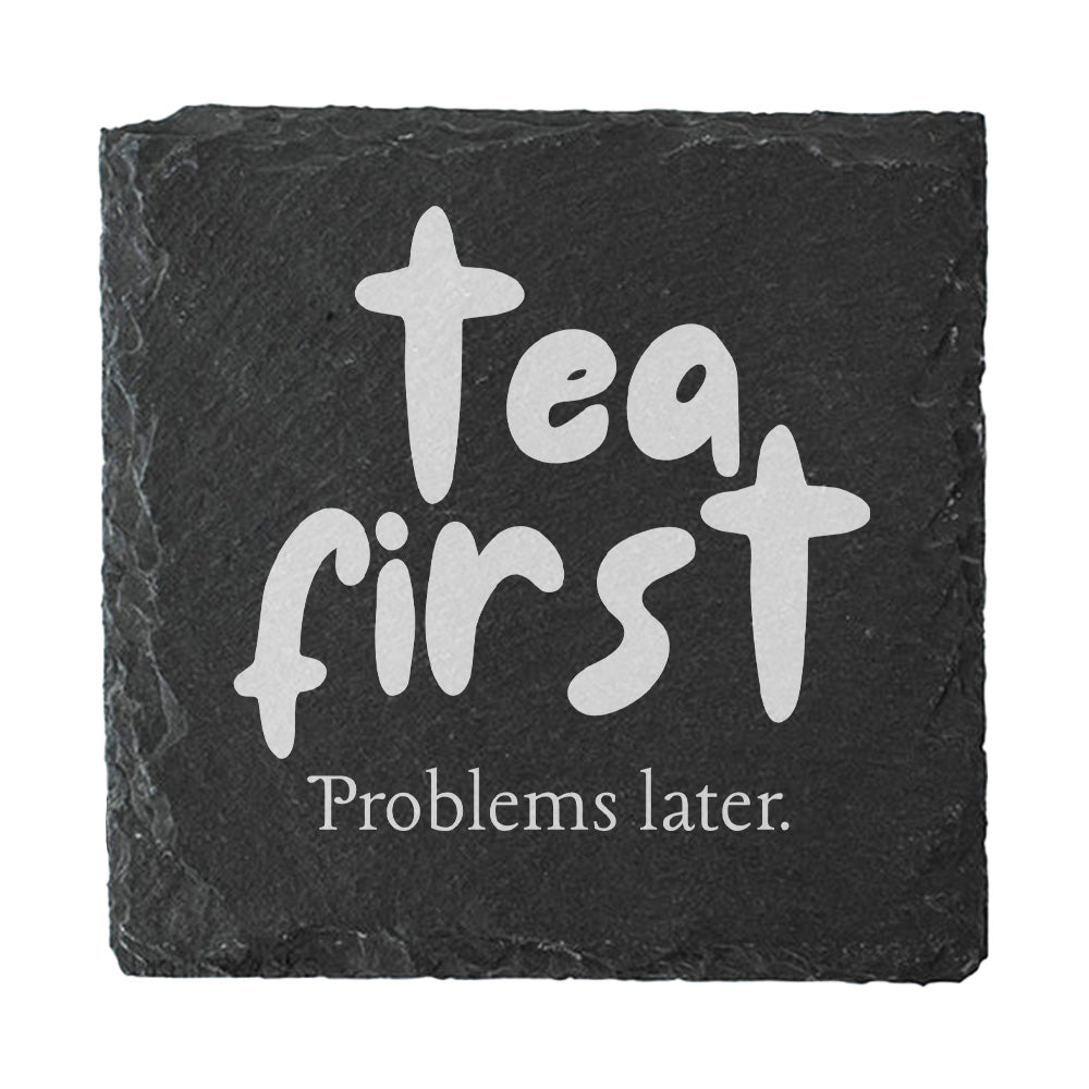 Slate coaster with 'Tea first Problems later' text on a white background