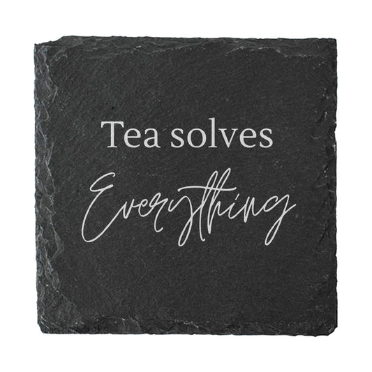 Slate coaster with 'Tea solves Everything' text on a white background