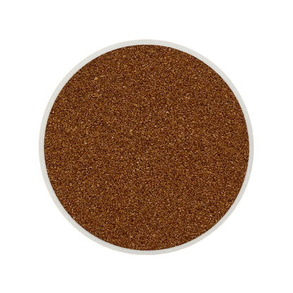 The back of a round ceramic coaster covered with cork to protect work surfaces.