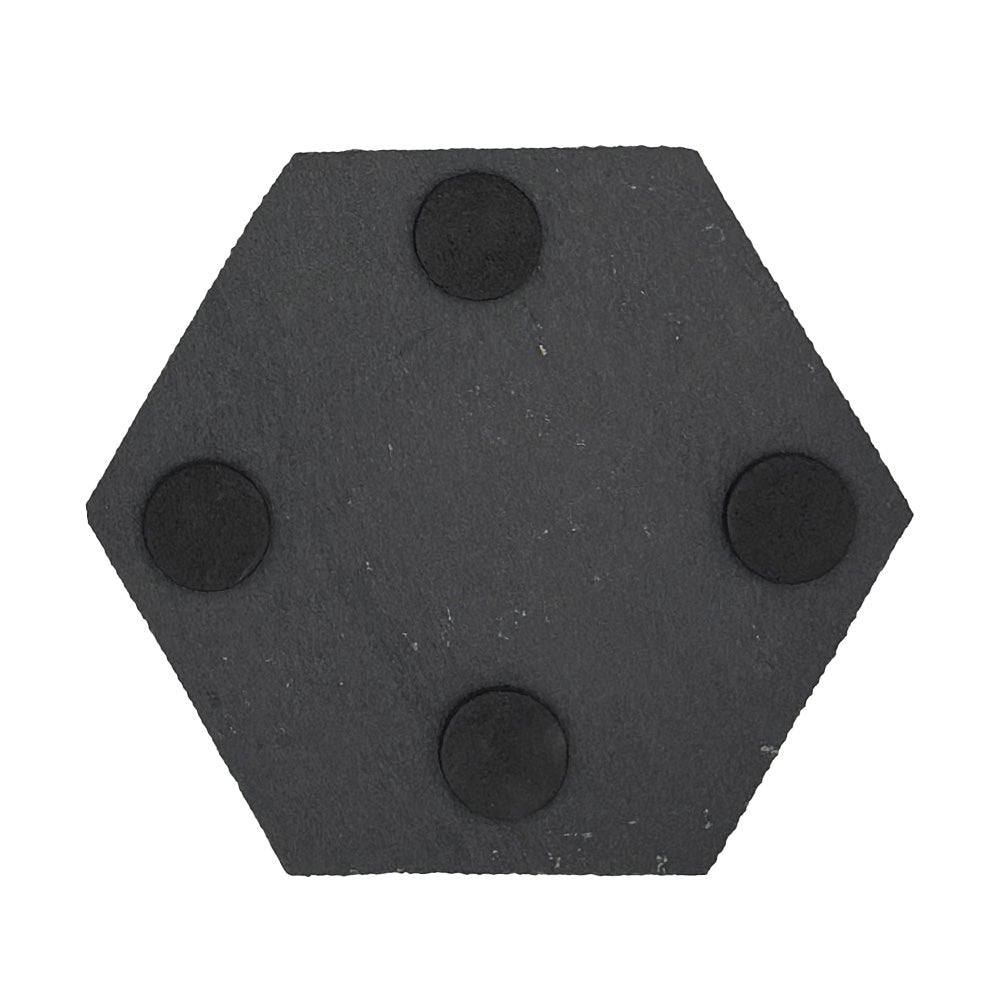 A hexagonal slate coaster with foam feet on the back to protect worksurfaces.