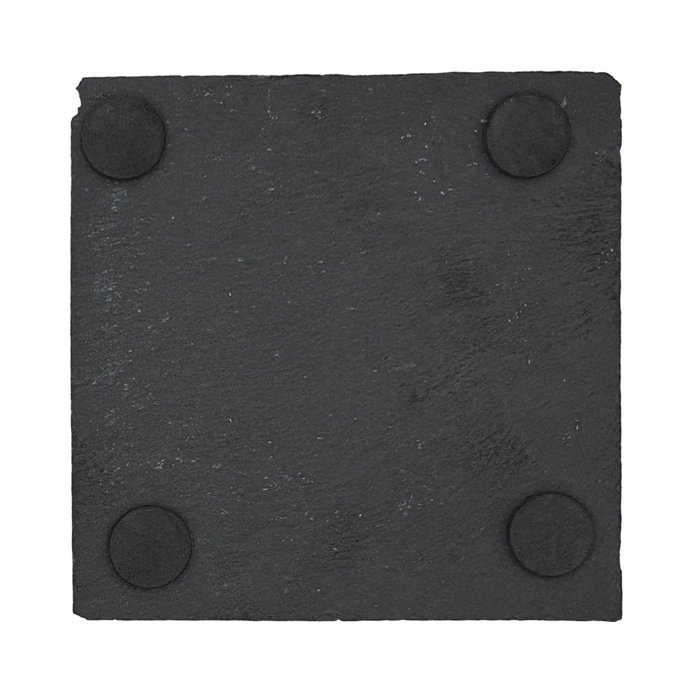 The back of a square slate coaster showing four foam feet on he back to protect worksurfaces.