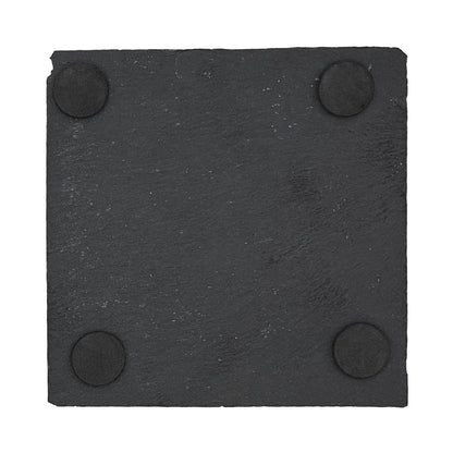The back of a square slate coaster showing four foam feet on he back to protect worksurfaces.