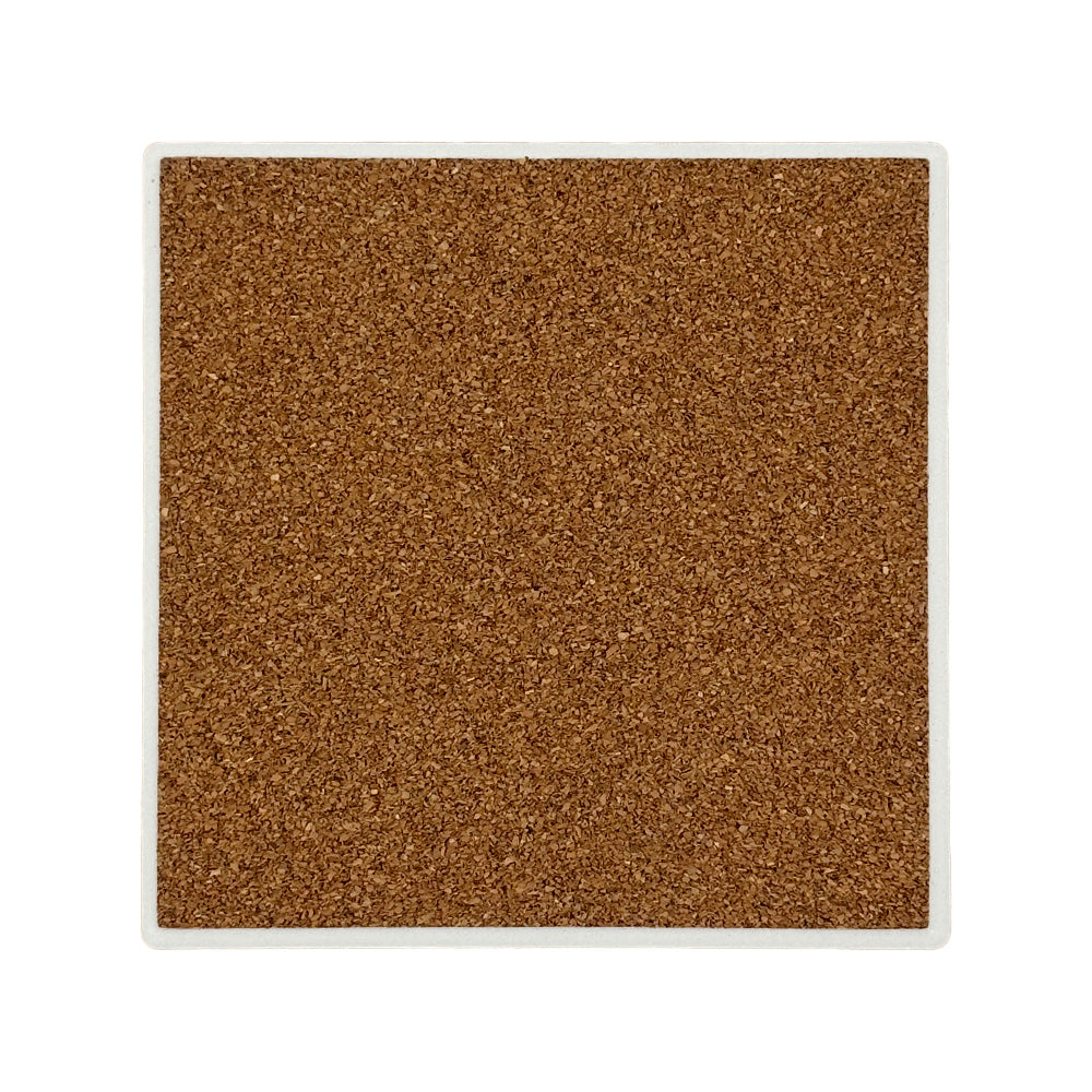 The back of a square ceramic coaster covered with cork to protect work surfaces and furniture.