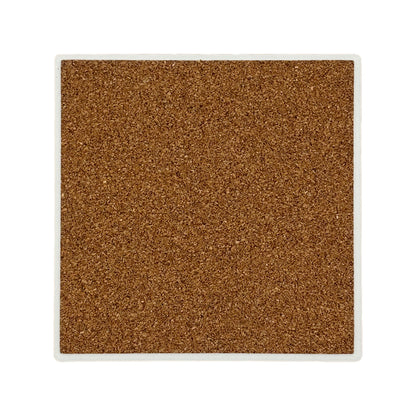 The back of a square ceramic coaster covered with cork to protect work surfaces and furniture.