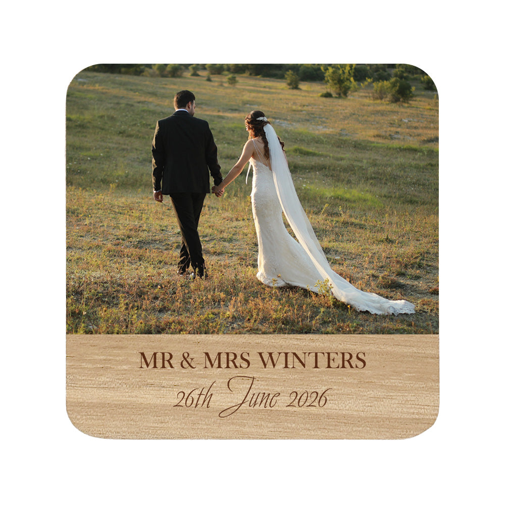 Personalised photo coaster of a wedding couple holding hands in a field with personalised names and date.