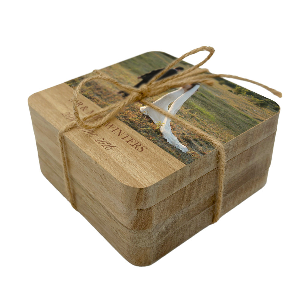 Personalised set of photo coasters of a wedding couple holding hands in a field with personalised names and date.