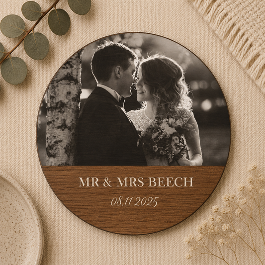 Round photo wooden coaster with a wedding photo and 'MR & MRS' name text on a decorative background.